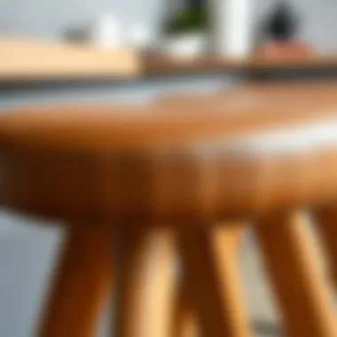 A close-up of the texture and finish of a light brown counter stool.